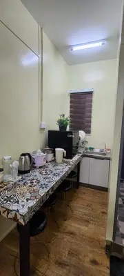 a kitchen with a table with pots and pans on it at Ummi Studio Homestay in Bayan Lepas