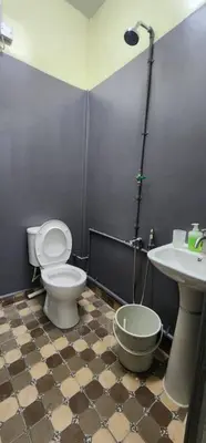 a bathroom with a toilet and a sink at Ummi Studio Homestay in Bayan Lepas