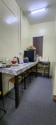 a table in a room with a counter with food on it at Ummi Studio Homestay in Bayan Lepas