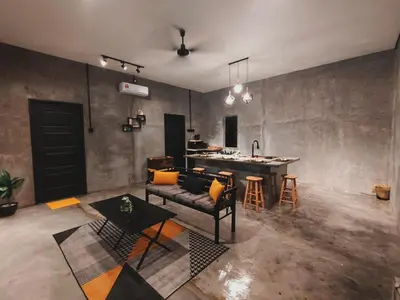 a living room with a couch and a table at Afqa Nest Industrial Charm in Gua Sai