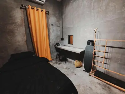 a bedroom with a bed and a tub in a room at Afqa Nest Industrial Charm in Gua Sai