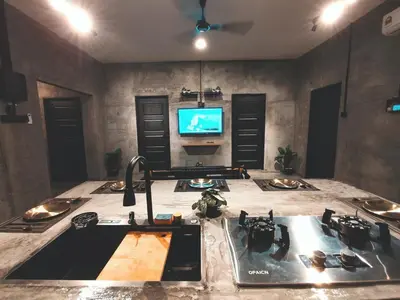 a kitchen with a sink and a tv in a room at Afqa Nest Industrial Charm in Gua Sai
