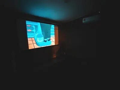 a dark room with a television with a toilet on it at Afqa Nest Industrial Charm in Gua Sai