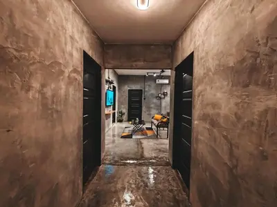 a hallway with brown walls and black doors at Afqa Nest Industrial Charm in Gua Sai