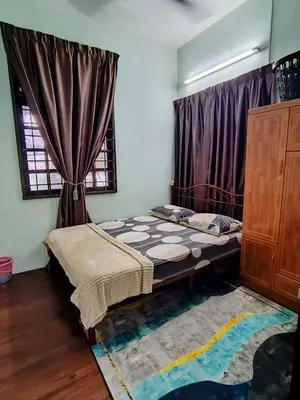 a bedroom with a bed and a window with curtains at Mairahomestay Tambun Islam Only in Tambun