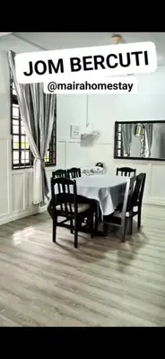 a dining room with a white table and chairs at Mairahomestay Tambun Islam Only in Tambun