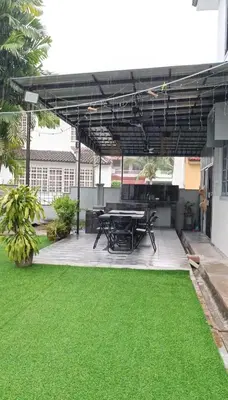 a patio with a picnic table and green grass at Mairahomestay Tambun Islam Only in Tambun