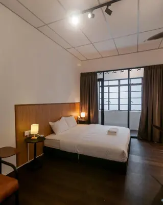 a hotel room with a bed and a window at Aayu Chowrasta - 3 mins walk to Penang Road Chendul in George Town