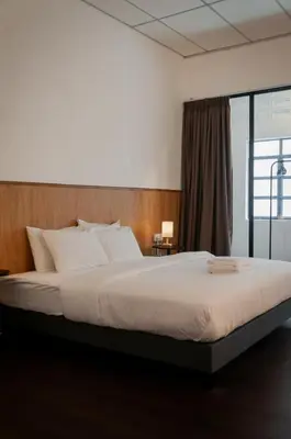 a large bed in a room with a window at Aayu Chowrasta - 3 mins walk to Penang Road Chendul in George Town