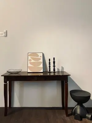 a wooden table with a book and a chair on it at Chowrasta Suites by Aayu George Town Penang in George Town