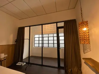 a room with a large window in a room at Chowrasta Suites by Aayu George Town Penang in George Town