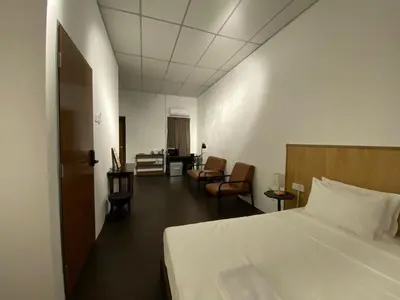 a hotel room with a bed and a table and chairs at Chowrasta Suites by Aayu George Town Penang in George Town