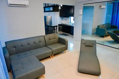 a living room with a couch and a kitchen at CK Home in Ipoh
