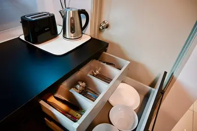 a black counter with a coffee maker and a toilet at CK Home in Ipoh