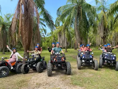 a group of people riding atvs on a field at Junior Suite Nature of Penang Guesthouse in Balik Pulau