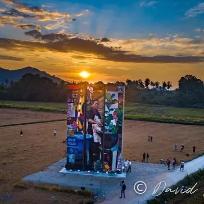 a monument with a picture of a man on it at sunset at Junior Suite Nature of Penang Guesthouse in Balik Pulau