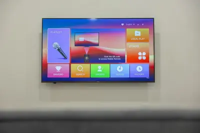 a television screen with a microphone on a wall at 7 \u53f7 Kota Cozy Homestay 3 storey 22pax-7 Room-SingK in Gua Sai