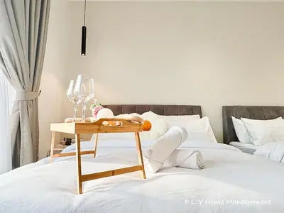 a bed with a table with a wine glass at HH Villa Private Pool Bercham Ipoh in Ipoh