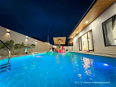 a large blue swimming pool at night at HH Villa Private Pool Bercham Ipoh in Ipoh