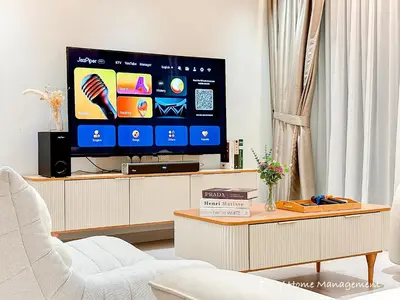 a living room with a flat screen tv on a cabinet at HH Villa Private Pool Bercham Ipoh in Ipoh