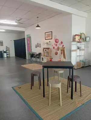 a table and some chairs in a room at Bajet Homestay - Teratak Singgah in Seri Iskandar