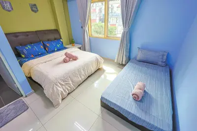 a bedroom with a bed with two stuffed animals on it at Modern Family Suite in Tanah Rata Cameron Highlands Clover Home K2 in Cameron Highlands