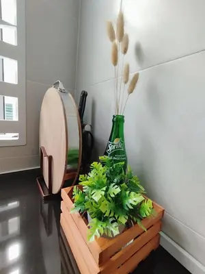 a vase with plants in it next to a mirror at Ipoh Home Story Newly Renovated Bercham Landed Double Storey For 10pax in Ipoh