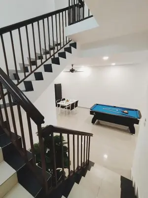 a staircase with a pool table in a living room at Ipoh Home Story Newly Renovated Bercham Landed Double Storey For 10pax in Ipoh