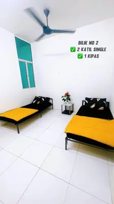 two beds in a white room with a ceiling at APPARTMENT Samudera Manjung Point in Seri Manjung