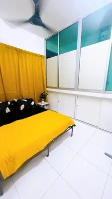 a bedroom with a yellow bed and a window at APPARTMENT Samudera Manjung Point in Seri Manjung