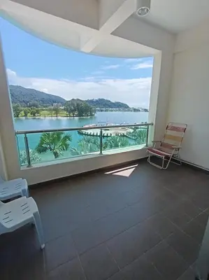 a room with a large window with a view of the water at Marina Island Lumut in Lumut
