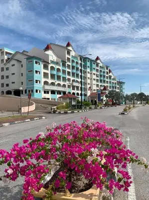 a bouquet of pink flowers in front of a building at Marina Island Lumut in Lumut