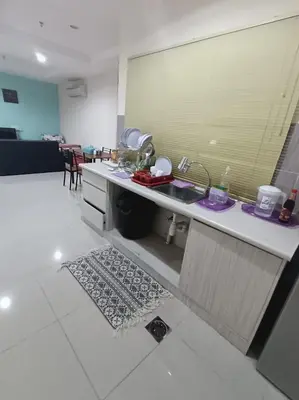 a kitchen with a sink and a counter top at Marina Island Lumut in Lumut