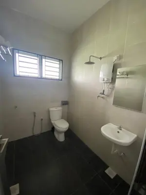 a white bathroom with a toilet and a sink at BBF Cozy Hub in Kamunting