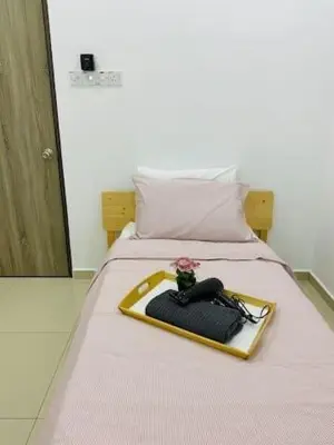 a bed with a tray with a flower on it at BBF Cozy Hub in Kamunting