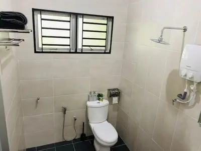 a bathroom with a toilet and a window at BBF Cozy Hub in Kamunting