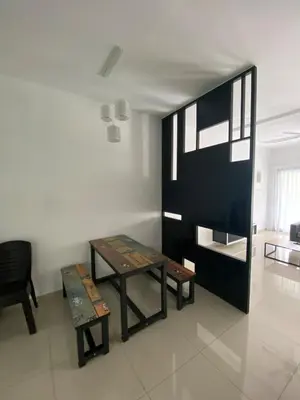 a living room with a table and a bench at BBF Cozy Hub in Kamunting