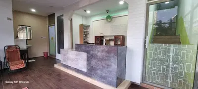 a lobby with a counter in the middle of a building at Zahaar KN Inn in Batu Ferringhi