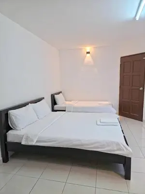 a bedroom with a large bed in a room at Zahaar KN Inn in Batu Ferringhi