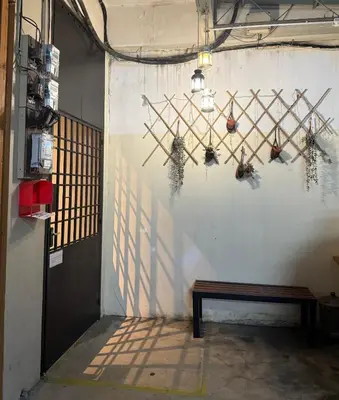 a wall with a bench in a room with a shadow at HuttonSTAY at Georgetown in George Town