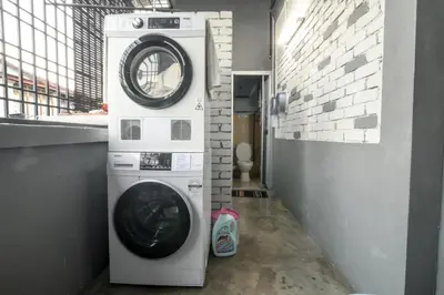 a washer and dryer in a room with a wall at HuttonSTAY at Georgetown in George Town