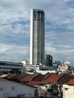 a tall white skyscraper in a city with roofs at HuttonSTAY at Georgetown in George Town