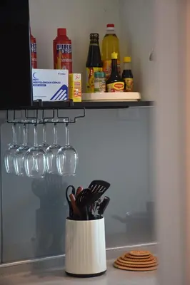 a container of kitchen utensils sitting on a counter at Maritime Suite by Ocean Luxe 2BR Seaview Dryer Water Dispenser in George Town