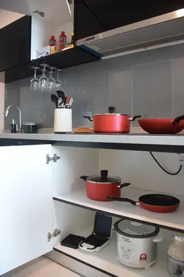 a kitchen with pots and pans on the shelves at Maritime Suite by Ocean Luxe 2BR Seaview Dryer Water Dispenser in George Town