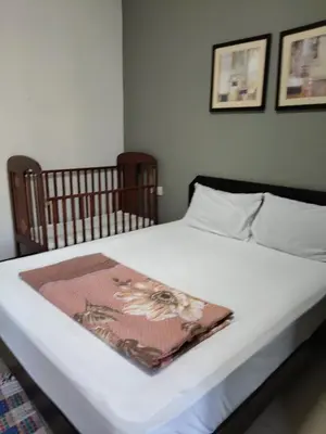 a bed with a blanket on top of it at Homestay Batu Ferringhi in Gua Sai