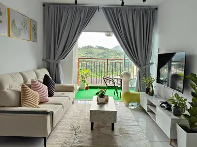 a living room with a couch and a tv at Dream 7 at Emerald avenue in Brinchang