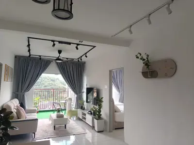 a living room with a couch and a window at Dream 7 at Emerald avenue in Brinchang