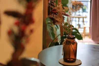 a vase with flowers in it sitting on a table at #MyUrbanGetaway at CameronFair, Cameron Highlands in Tanah Rata