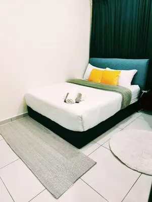 a bed with two shoes on it in a room at #MyUrbanGetaway at CameronFair, Cameron Highlands in Tanah Rata