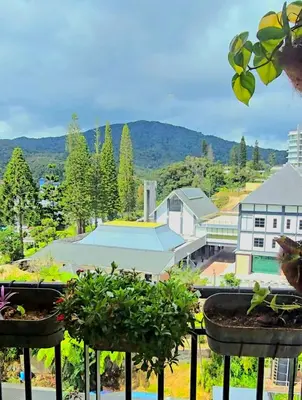 a view of a building with potted plants on a balcony at #MyUrbanGetaway at CameronFair, Cameron Highlands in Tanah Rata